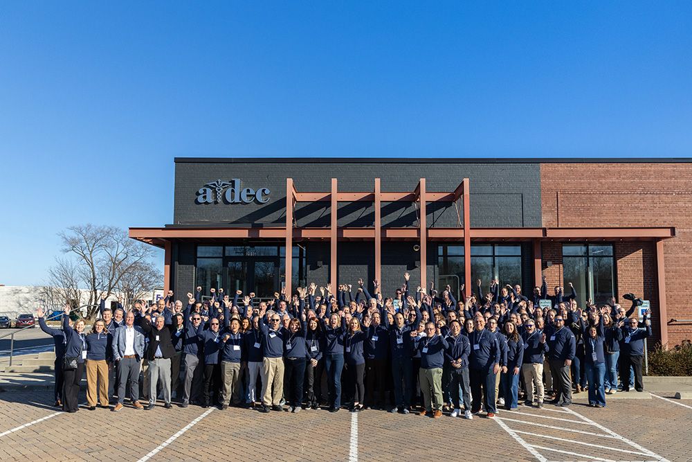 Benco and A-dec associates gather outside the A-dec Education Center to commemorate the partnership;